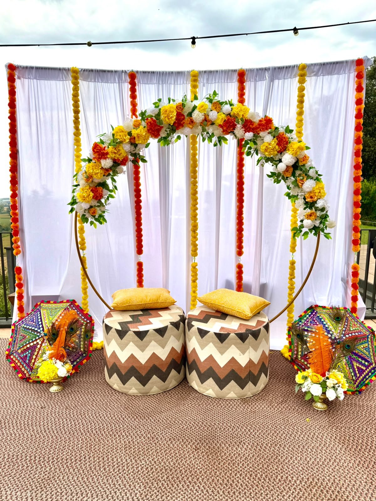 Sha Celebrations mehndi and haldi seating setup with marigold garlands